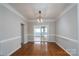 Dining room with hardwood floors, neutral walls, decorative lighting, and sliding glass doors to the sunroom at 303 Basswood Ct, Clover, SC 29710