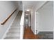 Open hallway featuring hardwood floors, staircase, and an open doorway leading to another room at 303 Basswood Ct, Clover, SC 29710