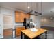 Kitchen features stainless steel appliances, wood cabinets, a kitchen island, and tile flooring at 303 Basswood Ct, Clover, SC 29710