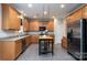 Kitchen boasts stainless steel appliances, tile floors, ample cabinets, and a center island with a butcher block top at 303 Basswood Ct, Clover, SC 29710