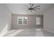 Bright main bedroom featuring a ceiling fan, neutral decor and carpeted floors with natural lighting at 303 Basswood Ct, Clover, SC 29710
