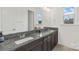 Bathroom vanity featuring dual sinks, granite countertops, and a large mirror at 3045 Bronwood Pl, Lancaster, SC 29720