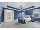 Stylish bedroom with a blue accent wall, modern lighting, and a cozy bed at 3045 Bronwood Pl, Lancaster, SC 29720