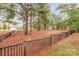 Community park with wooden perimeter fence, benches, and mature shade trees at 3045 Bronwood Pl, Lancaster, SC 29720