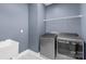 Modern laundry room with a utility sink and gray front-load washer and dryer at 3045 Bronwood Pl, Lancaster, SC 29720