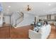 Open-concept living room featuring hardwood floors, staircase, and modern chandelier at 3045 Bronwood Pl, Lancaster, SC 29720