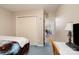 Bedroom featuring carpeted floors, a closet with doors, and an adjacent room visible through doorway at 3604 Oakwood Rd, Charlotte, NC 28269