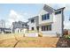 New construction home features a backyard with wood fence and a deck with steps down into the yard at 3937 Plainview Rd, Charlotte, NC 28208