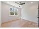 A minimalist bedroom offers ample natural light and pristine hardwood floors at 3937 Plainview Rd, Charlotte, NC 28208