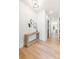 Bright entryway featuring hardwood floors, modern light fixture, contemporary console table and accent mirrors at 3937 Plainview Rd, Charlotte, NC 28208