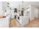 Spacious kitchen with white cabinetry, a large island, and stainless steel appliances at 3937 Plainview Rd, Charlotte, NC 28208