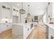 Modern kitchen featuring white cabinets, quartz countertops, stainless steel appliances, and pendant lighting at 3937 Plainview Rd, Charlotte, NC 28208