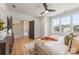 Light-filled main bedroom featuring hardwood floors, large windows, and access to a walk-in closet at 3937 Plainview Rd, Charlotte, NC 28208