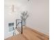 Bright staircase landing with modern railing and natural light, showcasing a stylish tree at 3937 Plainview Rd, Charlotte, NC 28208