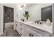 Modern bathroom with double vanity, sleek fixtures, and a walk-in shower at 3949 Plainview Rd, Charlotte, NC 28208