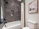 Bathroom featuring tiled shower, tub, and modern fixtures at 3949 Plainview Rd, Charlotte, NC 28208