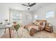 Bright bedroom featuring stylish furniture, a ceiling fan, and natural light at 3949 Plainview Rd, Charlotte, NC 28208