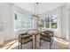 Dining room with hardwood floors, bright light, view of the beautiful outdoors, and seating for six at 3949 Plainview Rd, Charlotte, NC 28208