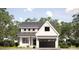 Charming new construction home featuring a modern farmhouse style with white siding, black accents, and a two-car garage at 3949 Plainview Rd, Charlotte, NC 28208