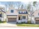 Charming two-story home featuring board and batten siding, a two-car garage, and professionally landscaped yard at 3949 Plainview Rd, Charlotte, NC 28208