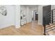 Inviting foyer with hardwood floors, modern staircase, and elegant decor that leads to the rest of the home at 3949 Plainview Rd, Charlotte, NC 28208