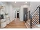 Inviting foyer with hardwood floors, modern staircase, and elegant decor that leads to the rest of the home at 3949 Plainview Rd, Charlotte, NC 28208