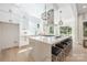 Open kitchen with large center island, stainless appliances, and black leather bar stools at 3949 Plainview Rd, Charlotte, NC 28208