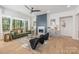 Cozy living room featuring a modern fireplace, hardwood floors, designer furniture, and bright windows for ample natural light at 3949 Plainview Rd, Charlotte, NC 28208