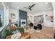 Cozy living room featuring a modern fireplace, hardwood floors, designer furniture, and bright windows for ample natural light at 3949 Plainview Rd, Charlotte, NC 28208