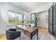 Office space with modern wooden desk, grey rug, and black french doors at 3949 Plainview Rd, Charlotte, NC 28208