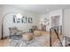 Stylish sitting area featuring comfortable chairs, ottomans, desk, and modern art, creating a versatile space at 3949 Plainview Rd, Charlotte, NC 28208