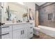 Well-appointed bathroom with modern fixtures, elegant decor, ample storage, and a combined tub/shower at 3953 Plainview Rd, Charlotte, NC 28208