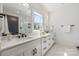 Modern bathroom boasting double sinks, sleek cabinetry, a well-lit mirror, and a bright window at 3953 Plainview Rd, Charlotte, NC 28208