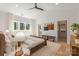 Spacious bedroom featuring a ceiling fan, large windows, ensuite bathroom, and a walk-in closet at 3953 Plainview Rd, Charlotte, NC 28208