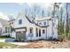 Modern farmhouse with two-car garage, board and batten siding, and covered front porch at 3953 Plainview Rd, Charlotte, NC 28208