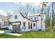Modern farmhouse with two-car garage, board and batten siding, and covered front porch at 3953 Plainview Rd, Charlotte, NC 28208