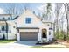 Modern farmhouse with two-car garage, board and batten siding, and covered front porch at 3953 Plainview Rd, Charlotte, NC 28208