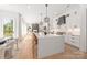 Spacious kitchen with a large island, modern lighting, and seamless flow to the living room at 3953 Plainview Rd, Charlotte, NC 28208