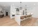 Bright and airy kitchen with an eat-in island, pendant lights, and stainless steel appliances at 3953 Plainview Rd, Charlotte, NC 28208