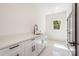 Bright laundry room with modern fixtures, sleek cabinetry, ample counter space, and natural light at 3953 Plainview Rd, Charlotte, NC 28208