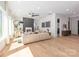 Sun-filled living room features a fireplace, hardwood floors, and modern furnishings at 3953 Plainview Rd, Charlotte, NC 28208