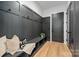 Mudroom features dark accent wall with hooks, bench and storage space at 3953 Plainview Rd, Charlotte, NC 28208