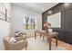 Home office with wood-paneled accent wall, natural light, and hardwood floors at 3953 Plainview Rd, Charlotte, NC 28208