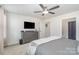 Spacious main bedroom featuring a ceiling fan, a dresser, and an ensuite bathroom at 4317 Stream Dale Nw Cir, Concord, NC 28027