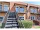 View of outdoor stairs leading to the units with private balconies and well-maintained shrubbery at 452 S Main St # F, Davidson, NC 28036