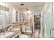 Bathroom with granite countertops, dual sinks, mirrored wall, and glass shower door at 452 S Main St # F, Davidson, NC 28036