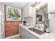 Close up view of kitchen with white cabinets, decor art piece, and a view to the living room at 452 S Main St # F, Davidson, NC 28036