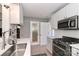 Modern kitchen featuring stainless steel appliances, white cabinets, and contemporary design at 452 S Main St # F, Davidson, NC 28036