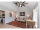 Living room with large ceilings, decorative rug, and a sofa near a table with wicker chairs at 452 S Main St # F, Davidson, NC 28036