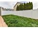 Fenced backyard space featuring well-maintained green grass and evergreen trees in a desirable neighborhood at 4708 Chantress Ln, Monroe, NC 28110
